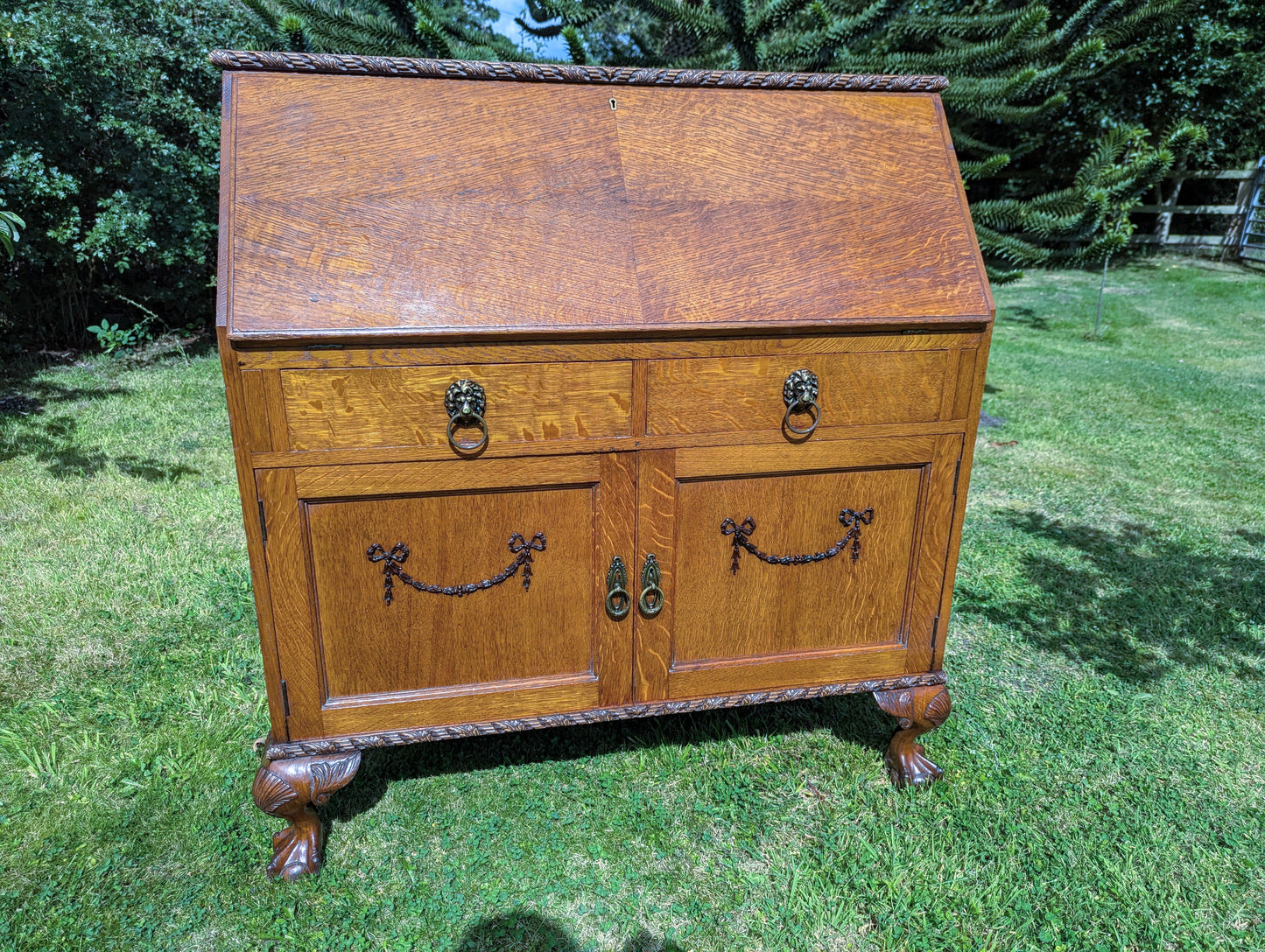 Antique early 20th century ball and claw feet bureau including secret compartment