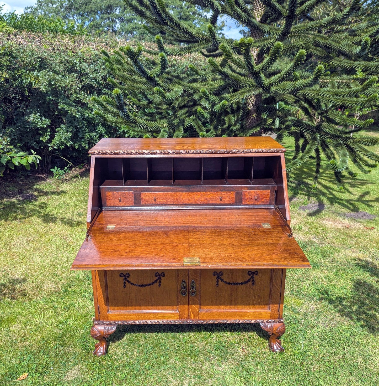 Antique early 20th century ball and claw feet bureau including secret compartment